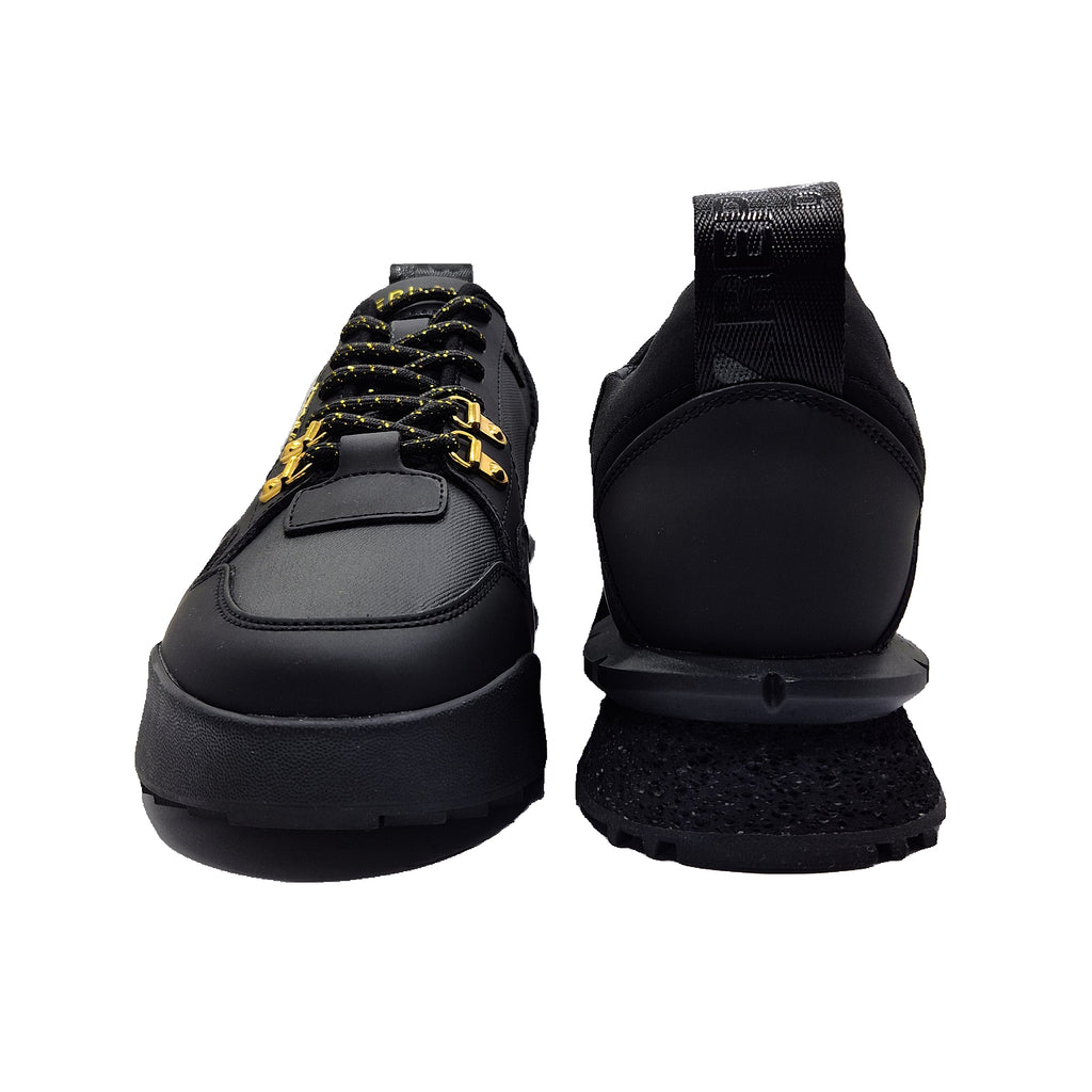 Black sneakers with yellow accents on a white background